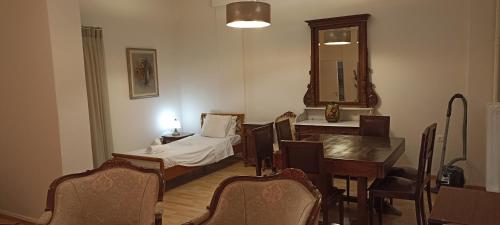a room with a table and a bed and a mirror at Amerikis Street 1 bedroom apartment in Athens
