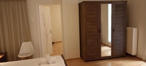 a room with a mirror and a white table and a room with a door at Amerikis Street 1 bedroom apartment in Athens