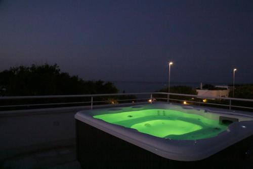 a hot tub on the roof of a building at night at Curri Case al Mare in Monopoli