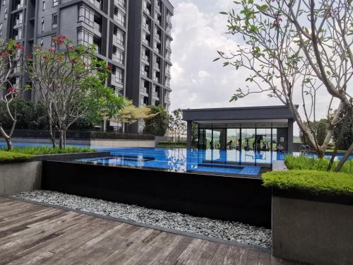 a swimming pool in a building with a gazebo at ALOCASIA Geniehome 3BR Free Wifi @ Utropolis Shah Alam in Shah Alam