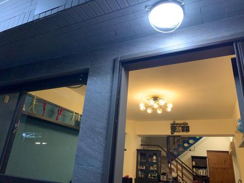 a room with a door and a chandelier on the ceiling at Duke 369 in Donggang