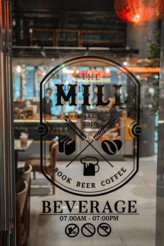 a glass door with a sign that says mitz beer conference at Hak Heng Hotel in Krong Poi Pet