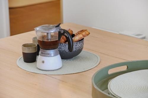 a blender sitting on a counter with a bowl of food at Sun Kissed - As close as you get to Pambula Beach in Pambula Beach