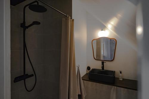 a bathroom with a shower and a mirror at Österlen loft in Tomelilla