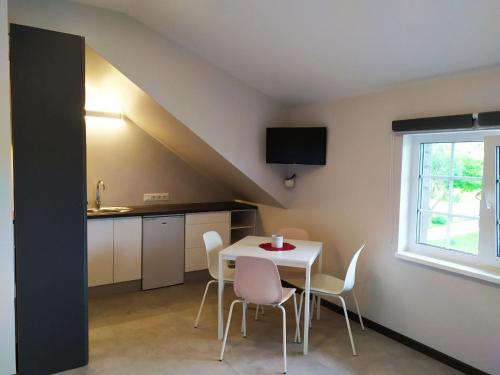 a kitchen and dining room with a table and chairs at "Trakaitis" apartments & holiday homes in Trakai