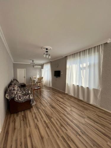 an empty living room with a bed and a table at Soft Villa in Gabala