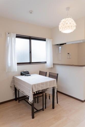 a dining room with a table and two chairs at HANASTAY花渓居 · 尺八（SYAKUHACHI) in Osaka