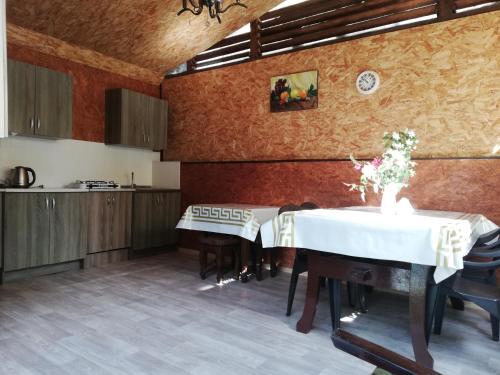 a dining room with a table and a kitchen at Guest House Assol in Loo