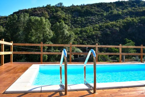 a swimming pool in front of a wooden fence at Agriturismo Peq Agri-Resort Tovo in Tovo San Giacomo