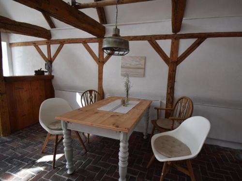 a dining room with a wooden table and chairs at Ferienhaus Galerie No 5 in Garding
