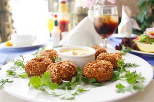 a plate of food with meatballs on a table at Al Diar Dana Hotel in Abu Dhabi