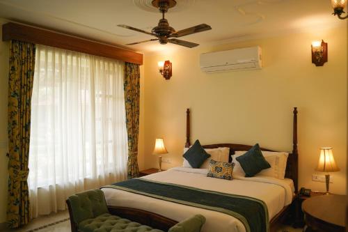 a hotel room with a bed and a window at Sariska Safari Lodge in Thāna Ghāzi