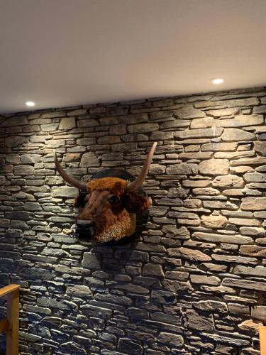 a stone wall with a bull head on it at Castorama in Rochehaut