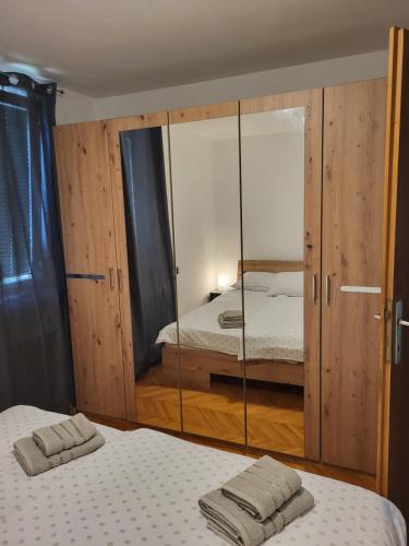 una camera con due letti e uno specchio di Sava river house - apartments a Bled