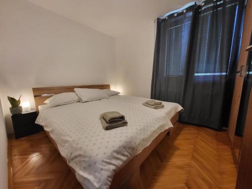 a bedroom with a bed with two towels on it at Sava river house - apartments in Bled