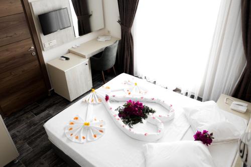 a room with a white table with flowers on it at Dream Town Hotel&Restaurant in Kemer