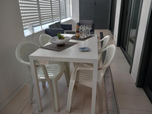 a white dining table and chairs in a room at Rome 66 apartments in Rome