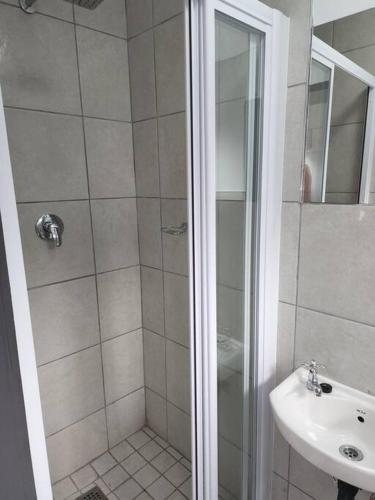 a bathroom with a shower and a sink at Grace Villas 7 in East London