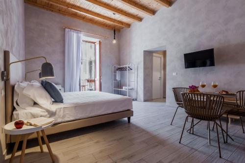 A bed or beds in a room at Five Stars Sicily by Ortigia Apartments