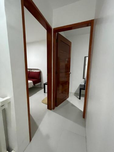 a hallway with a door and a chair in a room at Sto Niño Residences Lucena City in Lucena