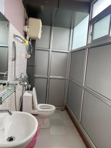 a bathroom with a toilet and a sink at The Palm Guest House in Kohīma