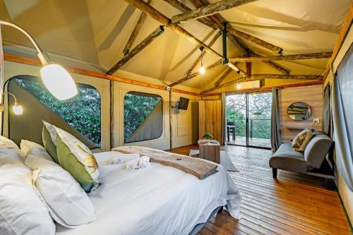 a bedroom with a large bed in a tent at Tranquil Nest in Hazyview