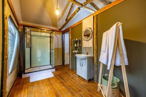 a bathroom with a glass shower and a sink at Tranquil Nest in Hazyview