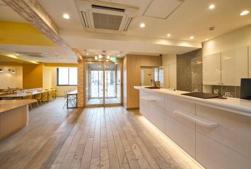a large room with a kitchen and a dining room at Hotel Axia Inn Sapporo Susukino in Sapporo