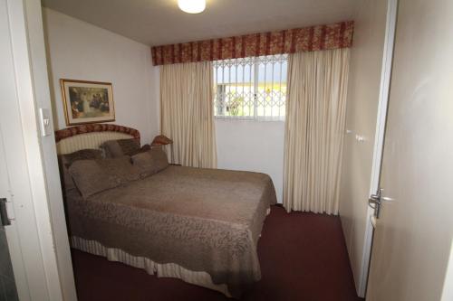 a small bedroom with a bed and a window at Boulevard 113 in Margate