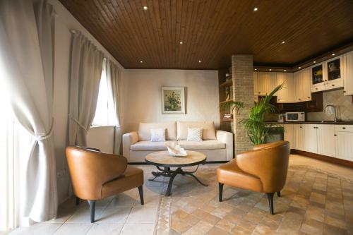 a living room with a couch and a table and chairs at Carvoeiro Beach Duplex in Carvoeiro