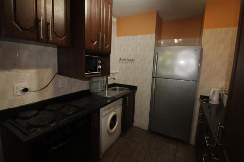 a kitchen with a stainless steel refrigerator and a dishwasher at Boulevard 114 in Margate