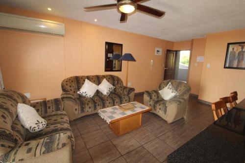 a living room with couches and a coffee table at Boulevard 114 in Margate