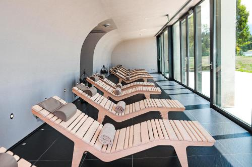 a row of benches in a room with windows at Villars Palace in Villars-sur-Ollon