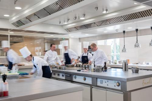 a group of chefs in a kitchen preparing food at Fleur de Loire in Blois