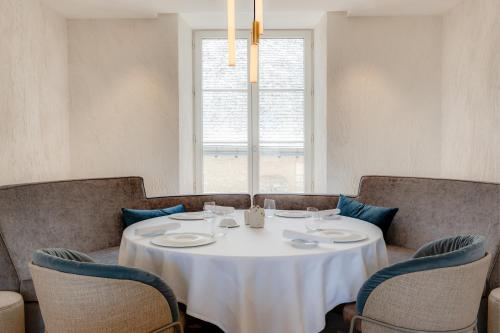 a table with chairs and a white table cloth on it at Fleur de Loire in Blois