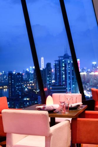 a table in a room with a view of a city at Shangri-La Shenzhen - Nearby Luohu Border, Outdoor Swimming Pool in Shenzhen