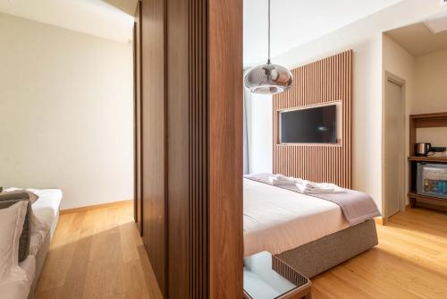 a hotel room with a bed and a tv at ELICAL Exclusive Private Suites in Rome