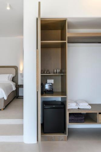 a bedroom with a bed and a tv in a room at Muro Suites in Ornos