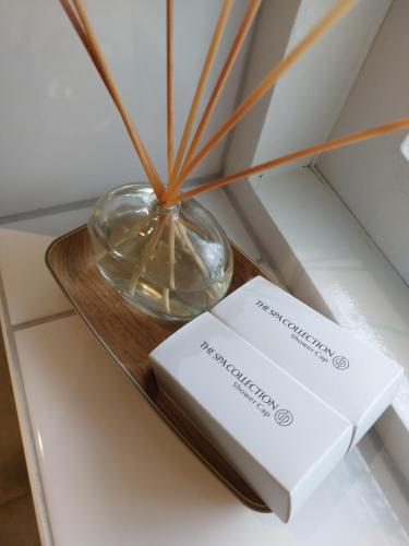 a glass bowl and a book on a table at B&B Poort van Westerwolde privé appartement met terras op zuiden in Alteveer