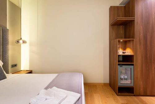 a bedroom with a bed with two towels on it at ELICAL Exclusive Private Suites in Rome