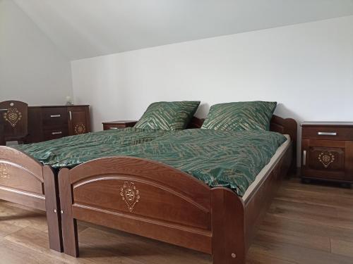 a bedroom with a wooden bed with wooden furniture at Dom Dobre Miejsce in Zawoja