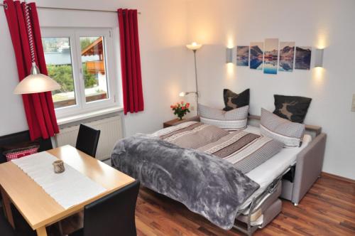 a bedroom with a bed and a table in it at Appartment Haus Birgit in Seefeld in Tirol