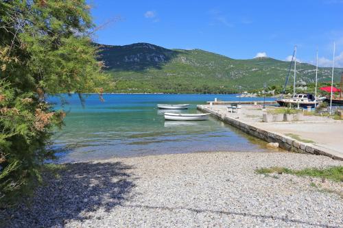 two boats are docked on the shore of a lake at Rooms with WiFi Ston, Peljesac - 19339 in Ston