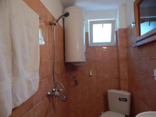 a bathroom with a toilet and a window at Villa Snejanka in Balchik