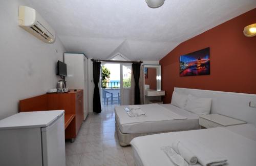 ein Hotelzimmer mit 2 Betten und einem Balkon in der Unterkunft Lale Otel in Turunç