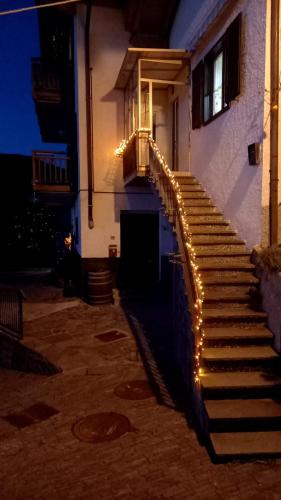 a staircase with lights on the side of a building at Apt. BELLA VISTA nel Cuore della Valle di Cembra. in Segonzano