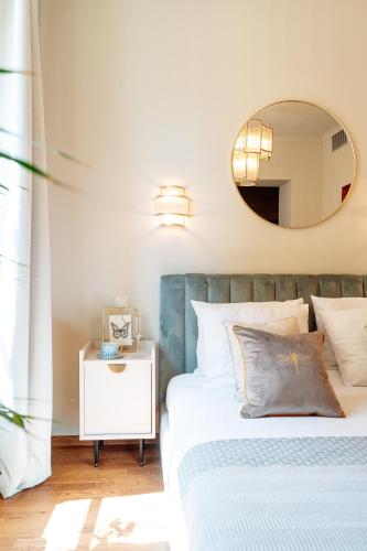 a bedroom with a bed and a mirror at Bogoria Residence - LoftAffair Collection in Kraków