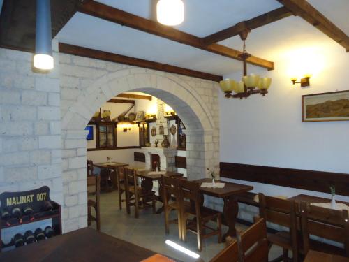 a dining room with tables and chairs in a restaurant at Hotel Klea in Berat