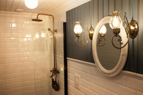 a bathroom with a mirror and a shower at Sylte Hotell, Valldal in Valldal