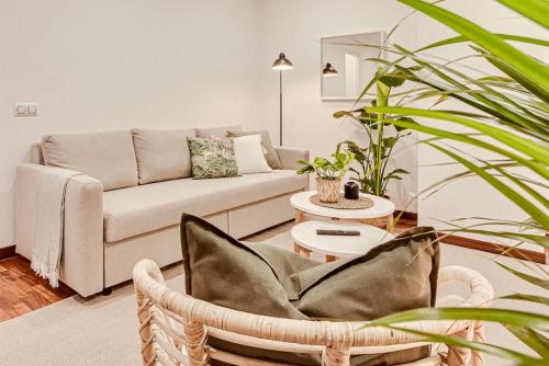 a living room with a couch and a chair at Quiet Marina Gardens Apartment in A Coruña